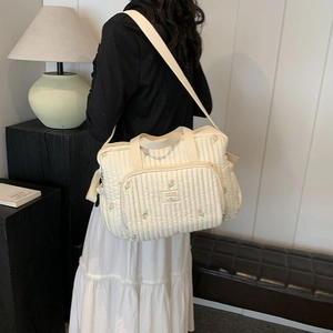 Quilted cream tote bag with pink tulip embroidery and adjustable shoulder strap for moms
