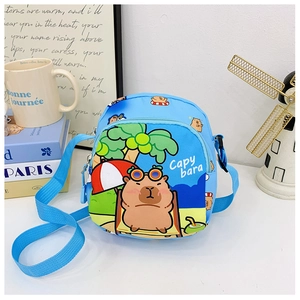 Detail of blue cartoon capybara shoulder bag with adjustable strap and summer beach print