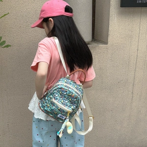 Mini cartoon toddler backpack with blue texture print and cute plush charm for outdoors