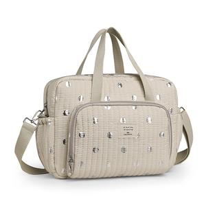 Quilted beige diaper bag with silver metallic dots and adjustable shoulder strap