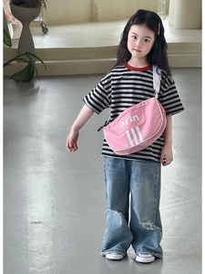 Detail of pink kids crossbody bag with white stripes and adjustable shoulder strap