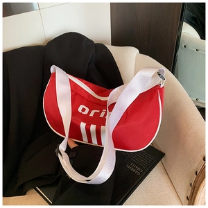Detail of red sporty nylon crossbody bag with white stripes and wide shoulder strap