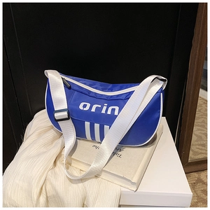 Detail of blue nylon crossbody bag with three stripes and adjustable white strap