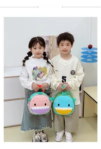 Pink and blue cartoon shark backpacks for toddlers shown in a bright indoor setting