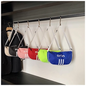 Detail showing various colors of nylon kids crossbody bags with adjustable straps and zipper