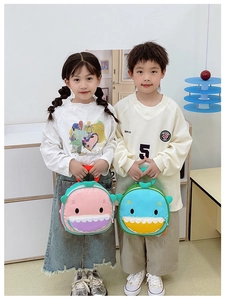 Detailed view of kids' cartoon shark lunch bags with 3D fins in pink and blue colors