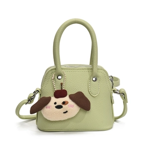 Green mini handbag for girls with cute cartoon puppy charm and textured faux leather