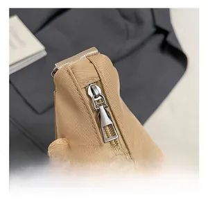Detail shot of the durable silver metal zipper on the khaki children's crossbody bag