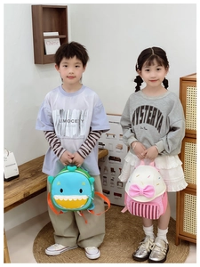 Detail shot of cute cartoon shark backpack and pink bow school bag for kids