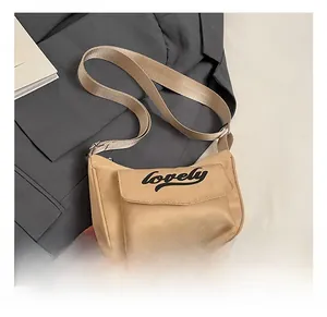 Detail showing the lovely letter print on the khaki shoulder bag flap with wide strap