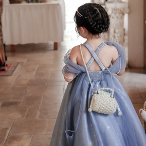Blue mesh girls party dress with cross-back design and a small pearl chain crossbody bag