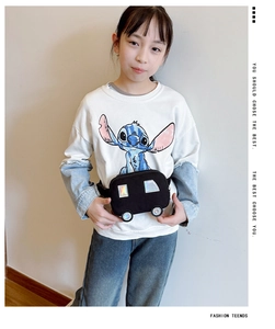 Detail of a black car-shaped canvas chest bag for kids featuring silver holographic accents