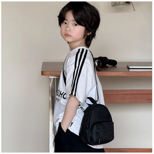 Détail d'un sac à bandoulière léger en nylon noir pour enfant dans un cadre décontracté
