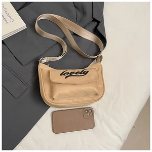 Detail of beige nylon crossbody bag with flap pocket and lovely text for kids