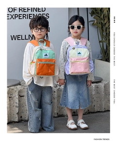 Outdoor street shot of kids wearing colorful high-capacity color-block backpacks