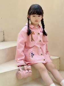Detail of pink cylinder handbag featuring a sweet bow accent for toddler girls fashion