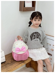 Detail view of pink bow and ice cream embroidery on kid backpack with mesh pocket