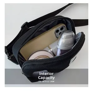 Detail view of the black canvas chest bag interior showing storage capacity for daily items