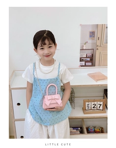 Pink mini crossbody bag for girls with large bow detail and elegant metal chain strap