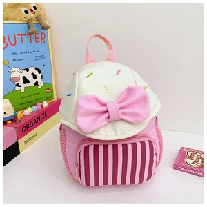Detail view of pink bow decoration and mesh side pocket on a cute kids backpack