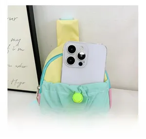 Détail de la poche avant d'un sac de poitrine en nylon coloré montrant l'espace de rangement