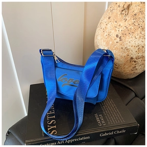 Close-up of royal blue nylon kids crossbody bag featuring black love script lettering