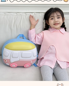 Detail of cute bus-shaped kids backpack featuring colorful hardshell waterproof design