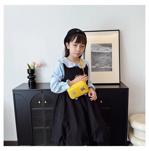 Detail of yellow car-shaped canvas crossbody bag with adjustable strap for kids