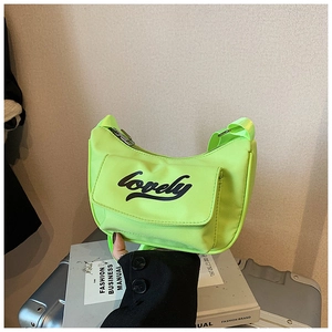 Detail of neon green kids crossbody bag featuring black Lovely lettering and front pocket
