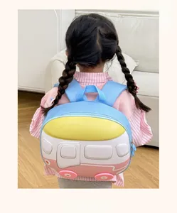 Detail view of pink and blue bus-shaped hardshell backpack worn by a toddler girl