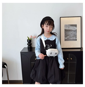 Close-up of a white car-shaped canvas crossbody bag for kids with cute cartoon design details