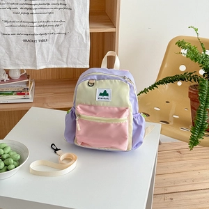 Detail of color-block kids backpack with anti-lost strap and durable nylon texture