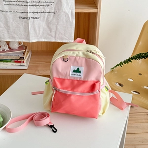 Detail of color-block kids backpack with detachable pink anti-lost safety leash