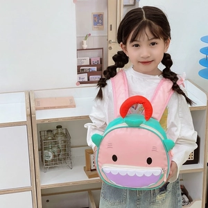 Pink shark-shaped backpack for kids with a mint green side and purple zipper pocket