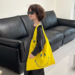 Vibrant yellow canvas tote bag with blue smiley face print for kids and casual daily use