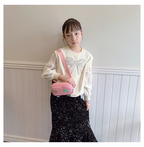 Close-up of pink car-shaped canvas crossbody bag with decorative wheels for kids