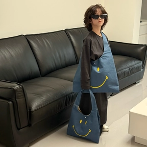 Blue canvas smiley face tote bags for kids in medium and large sizes with yellow print