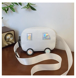 Detail of white canvas bus-shaped kid's crossbody bag with holographic patches