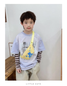 Detailed view of yellow kids chest bag with blue cartoon bear and little cute text