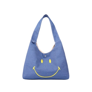 Kids blue denim shoulder bag with large yellow smiley face print and magnetic closure