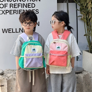 Fashionable large-capacity color-block school bag for children in outdoor setting