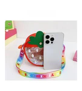 Detail of strawberry kid bag compared with a smartphone for size reference