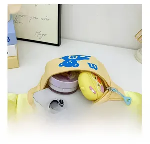 Detail view of yellow canvas kids chest bag showing inner storage capacity for essentials