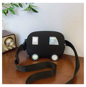 Detail of a black canvas car-shaped kids crossbody bag with silver reflective patches