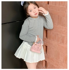 Pink mini crossbody bag for children with bear charm and classic pattern details