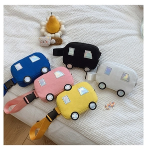 Detailed flat lay of cute car-shaped canvas bags for kids in five vibrant colors