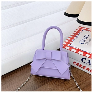 Detail of purple mini bow bag with matte leather finish and elegant silver chain strap
