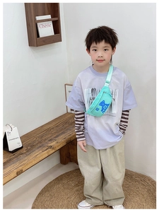 Boy wearing mint green chest bag with cute bear print and adjustable canvas strap