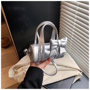 Detail of silver barrel bag for girls with large bow and metallic faux leather texture
