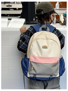 Detailed shot of large capacity color-block school backpack with mountain logo embroidery